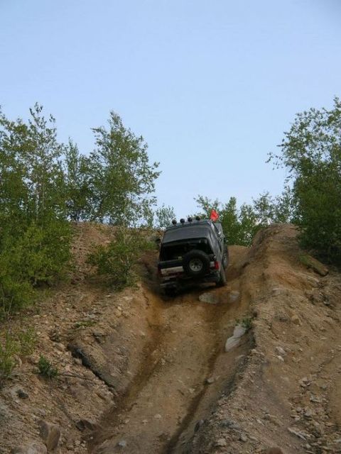 1995 Ford Bronco - SUV navigating a challenging off-road descent.