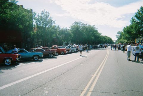 1972 Ford Ranchero - A sunny day with many cars parked along a street, possibly for a car show event.