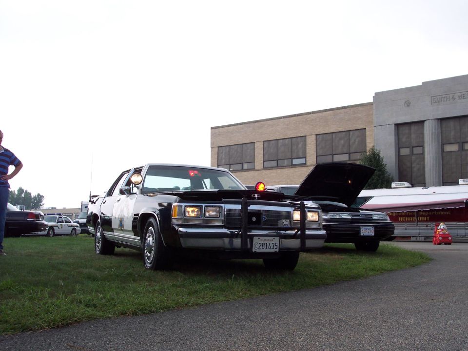 Black and white police car with push bumper and light bar