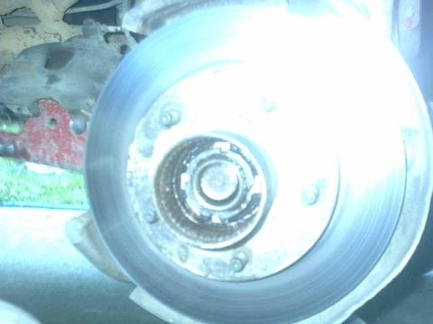1995 Ford Bronco - A close-up view of a vehicle's brake rotor and hub assembly is visible.