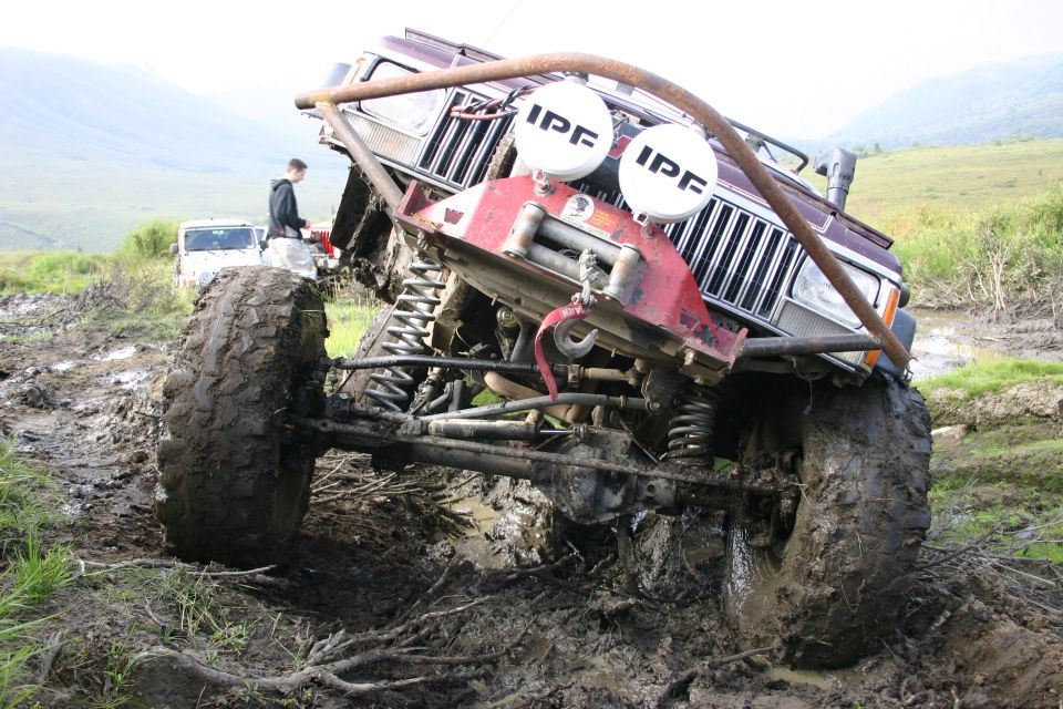 Modified Jeep Cherokee XJ stuck in mud with IPF lights. Another Jeep visible in background