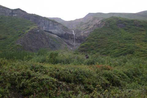 2003 Jeep TJ - A waterfall flows down a mountain in a lush, green valley.