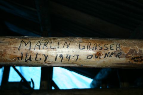 2003 Jeep TJ - A wooden log displays carved names and dates, including 'MARLIN GRASSER JULY 1947 OWNER'.