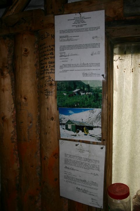 2003 Jeep TJ - Pinned documents and photos are displayed on a rustic log wall, including official state paperwork and scenic images.