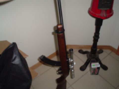 1981 Ford Bronco - A rifle with a scope and magazine is shown next to a decorative lamp.