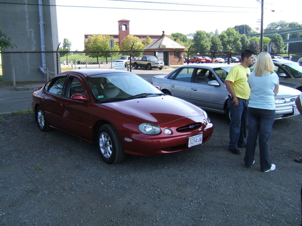 Red 1998 Ford Taurus 3/4 front view with license plate 3254 JA