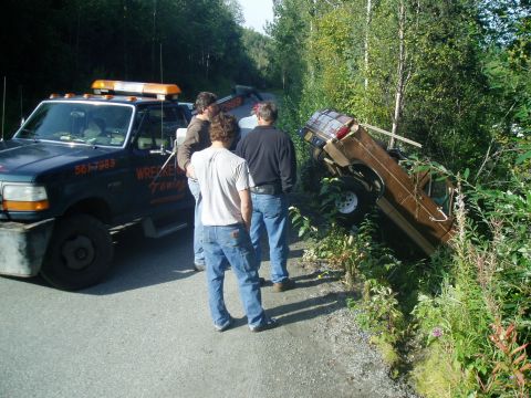 1989 Ford Bronco - just about out, except the wrecker wa out of room to pull, so we hooked up my dad's truck w/ a chain to hold her in place, while the wrecke…