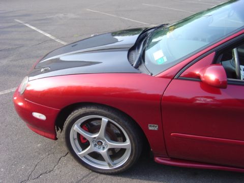 1998 Ford Taurus - Front quarter view of a red 1998 Ford Taurus, a contrasting black hood and custom wheels.
