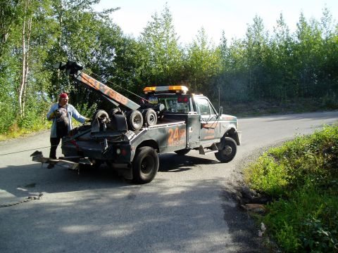 1989 Ford Bronco - wrecker almost lifting a tire, it was off the ground earlier, but he lowered the boom and set it back down