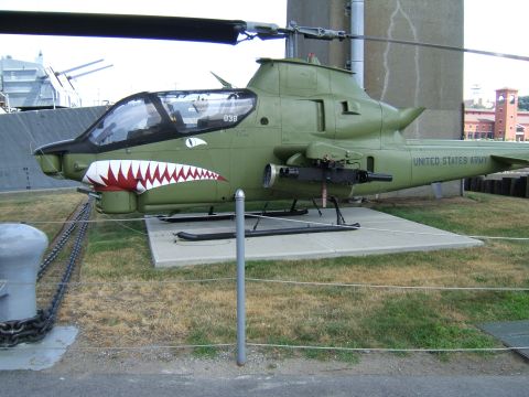 1998 Ford Taurus - AH-1 Cobra attack helicopter with shark mouth markings and mounted machine gun.