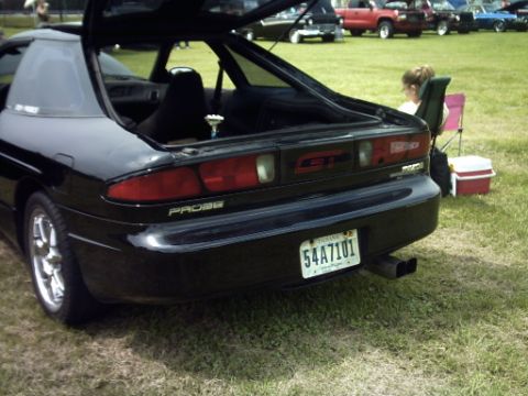 1995 Ford Probe - Rear view of a black 1995 Ford Probe GT at an outdoor event.