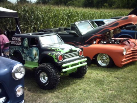 1995 Ford Probe - Multiple custom vehicles are displayed outdoors with a cornfield in the background.