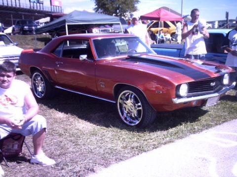 1995 Ford Probe - A classic 1969 Chevrolet Camaro SS is displayed at an outdoor event.
