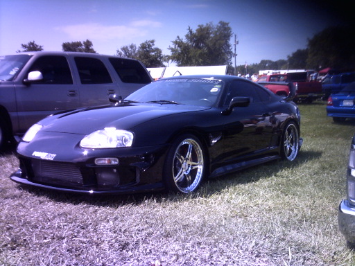 Black sports car with custom wheels, front view