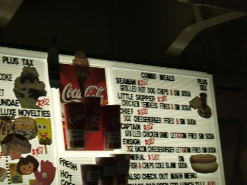 1998 Ford Taurus - A menu board displays various combo meal options and prices, alongside Coca-Cola advertisements.