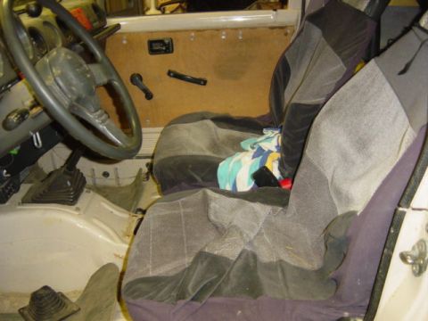 1987 Suzuki Samurai - The interior of a vehicle is shown, with a focus on the driver's side and passenger seat.