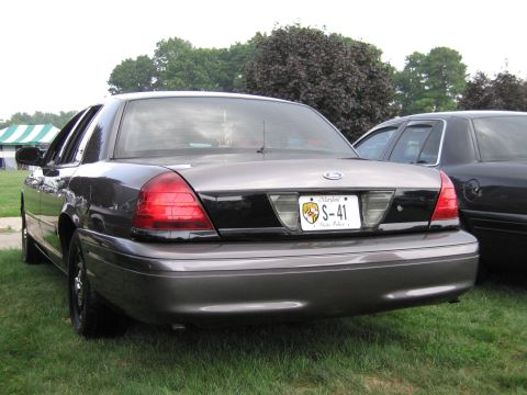 1991 Ford LTD Crown Victoria - Rear three-quarter view of a gray Ford Crown Victoria sedan on grass, showing a Maryland 'S-41' plate.