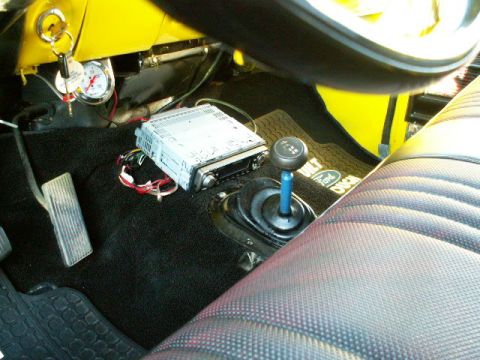 1979 Ford Bronco - Interior view of a 1979 Ford Bronco, a floor shifter and an aftermarket stereo unit.