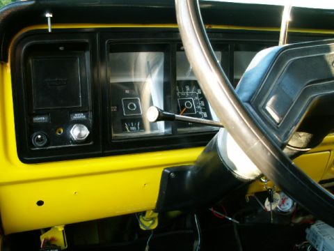 1979 Ford Bronco - Close-up of a vehicle's interior dashboard, gauges and controls.