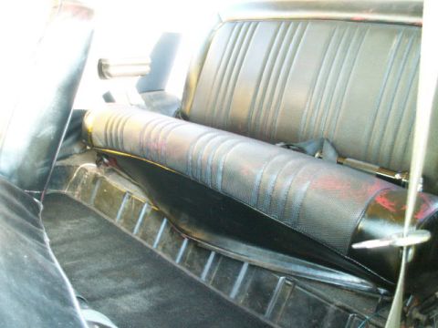1979 Ford Bronco - The interior of a 1979 Ford Bronco shows the rear seat and seatbelt, with patterned upholstery.