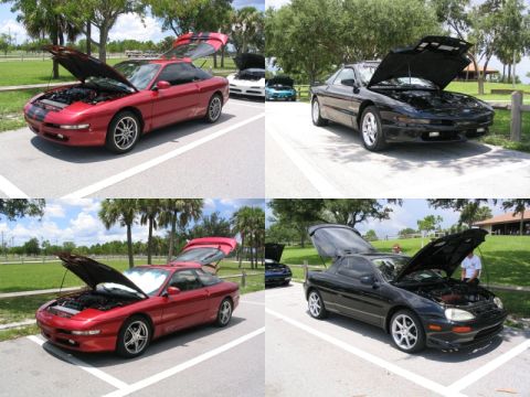 1997 Ford Probe - Multiple coupes are parked with their hoods and trunks open, suggesting a car show or meet.