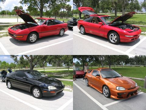 1997 Ford Probe - A red coupe is shown with its hood and trunk open, parked in a lot with other vehicles.
