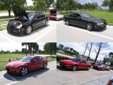 1997 Ford Probe - A red Ford Probe is parked in a lot with other vehicles, under a bright sky.