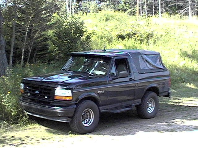 Black 1995 Ford Bronco with soft top parked outdoors