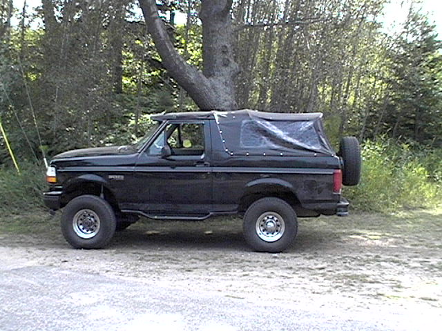 Black 1995 Ford Bronco with soft top and spare tire on rear