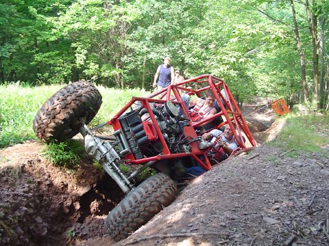 1979 Ford Bronco - This custom off-road buggy appears to be stuck in a ditch while navigating a wooded trail.