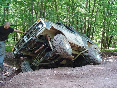 1979 Ford Bronco - A 1979 Ford Bronco is stuck at an extreme angle in a dirt ditch during an off-road excursion.