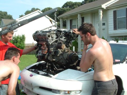 1996 Ford Probe - Engine removal and installation in progress with a crane assisting the process.