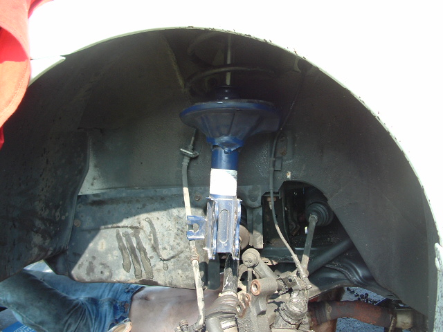 Front wheel well and suspension components with blue shock absorber