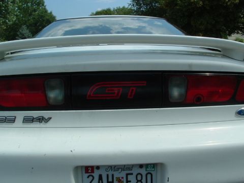 1996 Ford Probe - The rear of a white car shows a GT badge and a 24V emblem.