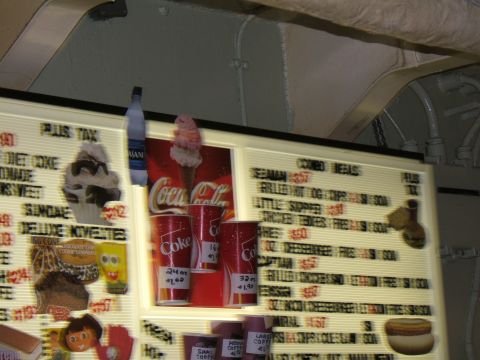 1998 Ford Taurus - A menu board shows various food and drink items, with Coca-Cola branding visible.