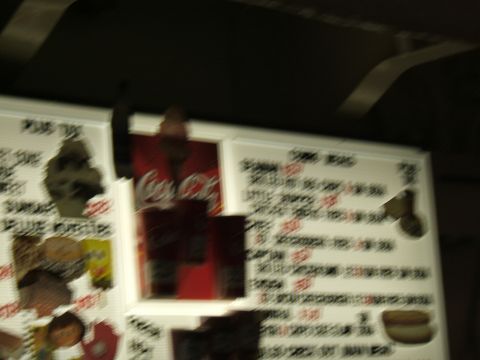 1998 Ford Taurus - A blurry photo shows a menu board with a Coca-Cola advertisement and a list of items.