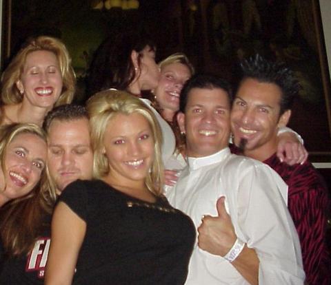 2005 BMW 3 Series - A group of friends gather for a photo, with some people kissing and others smiling.