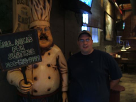 1998 Ford Taurus - A man poses next to a chef statue holding a sign with a phone number.