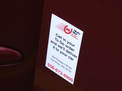 1998 Ford Taurus - A sticker for a local delivery service is affixed to the side of a vehicle.
