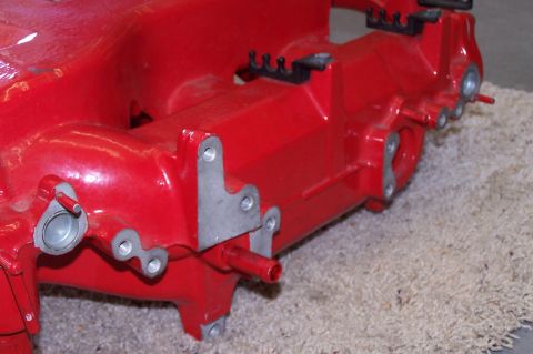 1997 Ford Probe - A red engine intake manifold is shown up close, with visible mounting points and small tubes.