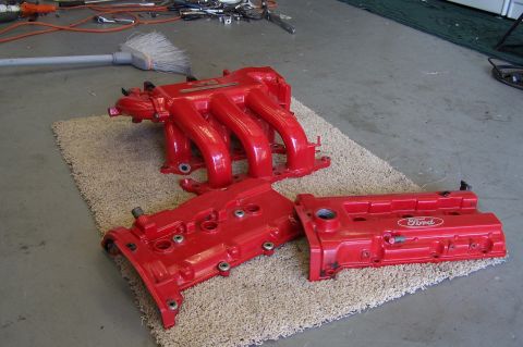 1997 Ford Probe - Red Ford intake manifold and valve covers are shown on a rug, with tools and a broom visible in the background.