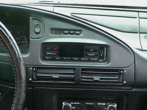 1992 Ford Taurus - The dashboard features a digital clock, climate controls, and an aftermarket stereo system.