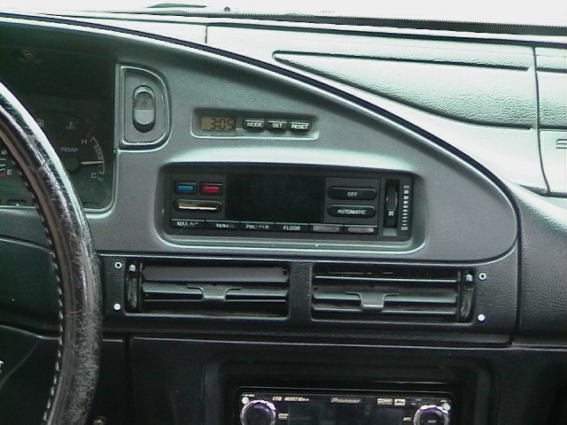 Dashboard with radio, climate controls, and a digital clock showing 3:09