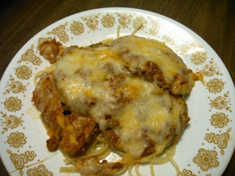 1992 Ford Probe - A close-up view of a plate of spaghetti covered in meat sauce and cheese, with a Supermotors logo in the corner.