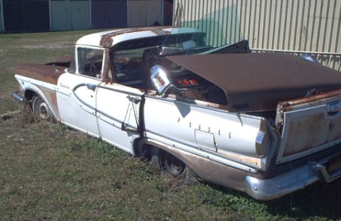 1970 Ford Ranchero - This abandoned Ford Ranchero is in a state of disrepair, with rust visible on its hood and bed cover.