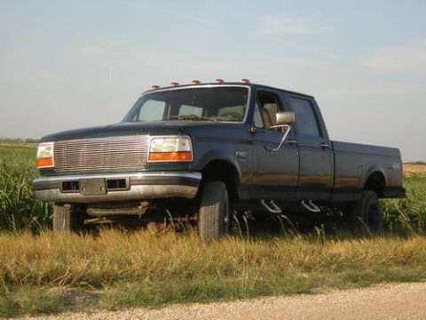 1996 Ford F-350 - This truck appears to be from the mid-1990s, likely a Ford F-250 or F-350, with a crew cab and long bed.