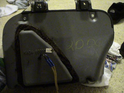 1997 Ford Probe - This is a gray automotive part with some writing and a label.