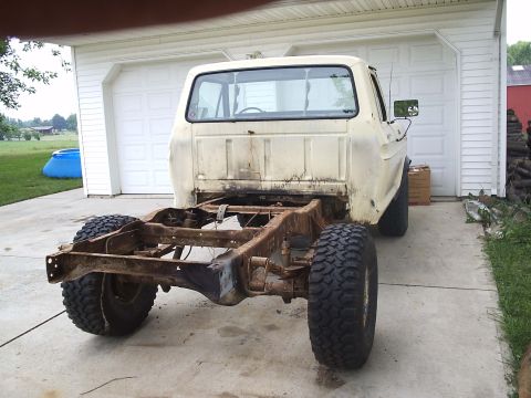 1979 Ford F-150 - The rear frame and suspension of a vintage Ford pickup truck are visible, with the cab and wheels intact.