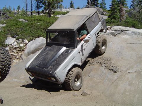 1967 Ford Bronco - This vehicle is navigating a rocky trail, with its tires angled on the uneven terrain.