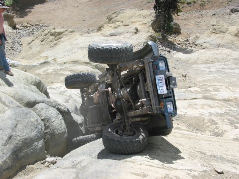 1982 Ford Customline - An off-road vehicle has overturned while navigating a difficult rocky terrain.